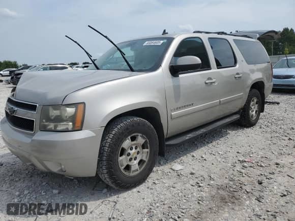 2007 Chevrolet Suburban LT z VIN 3GNFC16027G135928, wystawiony jako Copart lot #66864605 z przebiegiem 289 418 mil mil oraz Szkoda całkowita • Salvage title. Historia ofert i sprzedaży dostępna na DreamBid. Obrazek 1.
