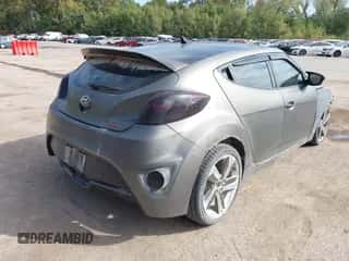 2014 Hyundai Veloster Turbo z VIN KMHTC6AE8EU185735, wystawiony jako IAAI lot #43430533 z przebiegiem 120 337 mil mil oraz . Historia ofert i sprzedaży dostępna na DreamBid. Obrazek 4.