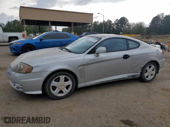 2003 Hyundai Tiburon GT с VIN KMHHN65F13U013420, выставлен на аукционе Copart как лот 51234495 с пробегом 230 612 миль миль и Списание • Salvage title. История ставок и продаж доступна на DreamBid. Изображение 1.