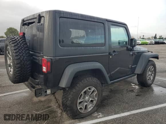 2015 Jeep Wrangler Rubicon with VIN 1C4BJWCG5FL629648, listed as a Copart auction lot 82550674 with 54,853 mi miles and Salvage title. Bid and sale history available at DreamBid. Image 3.