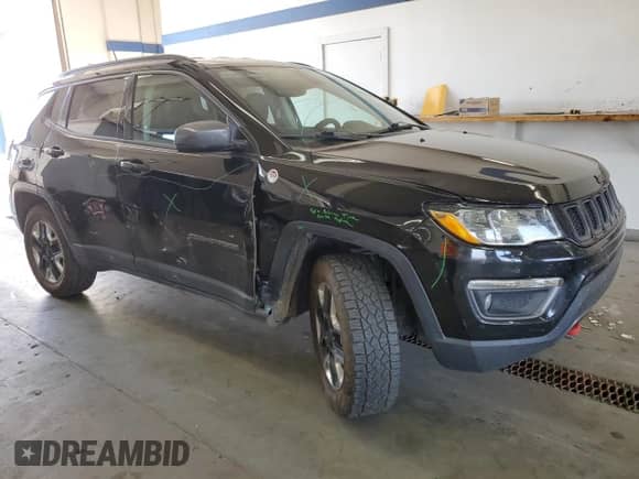 2017 Jeep Compass Trailhawk with VIN 3C4NJDDBXHT647011, listed as a Copart auction lot 65583185 with 106,438 mi miles and Salvage title. Bid and sale history available at DreamBid. Image 4.