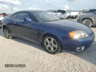 2003 Hyundai Tiburon с VIN KMHHM65D03U095741, выставлен на аукционе Copart как лот 55147305 с пробегом 170 946 миль миль и Списание • Salvage title. История ставок и продаж доступна на DreamBid. Изображение 4.