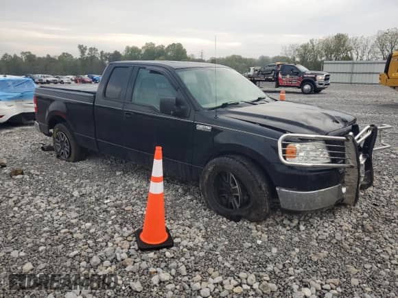 2005 Ford F-150 XLT with VIN 1FTPX12595NA46140, listed as a Copart auction lot 82141515 with 156,879 mi miles and Salvage title. Bid and sale history available at DreamBid. Image 4.