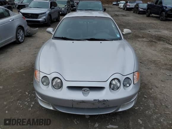2001 Hyundai Tiburon с VIN KMHJG35F31U224416, выставлен на аукционе Copart как лот 83243684 с пробегом 59 473 миль миль и Списание • Salvage title. История ставок и продаж доступна на DreamBid. Изображение 5.