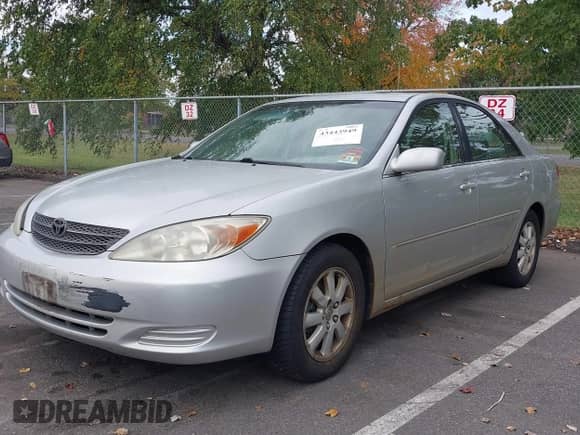 2002 Toyota Camry LE with VIN 4T1BE30K22U601060, listed as a IAAI auction lot 43443949 with 241,972 mi miles and . Bid and sale history available at DreamBid. Image 2.
