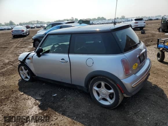 2004 MINI Hardtop with VIN WMWRC33454TJ56308, listed as a Copart auction lot 59690865 with 99,374 mi miles and Salvage title. Bid and sale history available at DreamBid. Image 2.