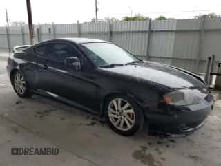 2005 Hyundai Tiburon GT с VIN KMHHN65F55U175179, выставлен на аукционе Copart как лот 89319685 с пробегом 220 117 миль миль и Чистый • Clean title. История ставок и продаж доступна на DreamBid. Изображение 4.