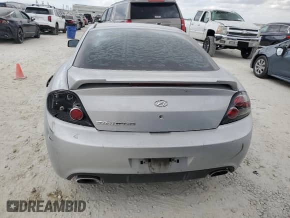 2008 Hyundai Tiburon GS с VIN KMHHM66DX8U295094, выставлен на аукционе Copart как лот 78100674 с пробегом 143 506 миль миль и Списание • Salvage title. История ставок и продаж доступна на DreamBid. Изображение 6.