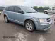 2013 Dodge Journey American Value z VIN 3C4PDCAB6DT665336, wystawiony jako IAAI lot #43511976 z przebiegiem 185 019 mil mil oraz . Historia ofert i sprzedaży dostępna na DreamBid. Obrazek 1.