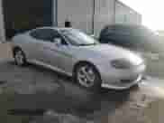 2006 Hyundai Tiburon GS z VIN KMHHM65D06U205823, wystawiony jako Copart lot #87125445 z przebiegiem 158 410 mil mil oraz Czysty tytuł • Clean title. Historia ofert i sprzedaży dostępna na DreamBid. Obrazek 4.