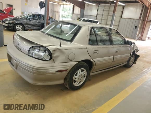 1998 Pontiac Grand Am SE with VIN 1G2NE52T3WM506391, listed as a Copart auction lot 57699325 with 79,508 mi miles and Salvage title. Bid and sale history available at DreamBid. Image 3.