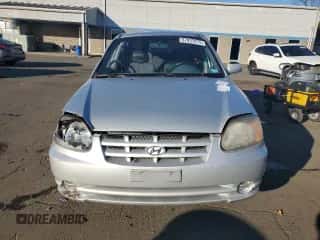 2005 Hyundai Accent GLS with VIN KMHCG45C15U635114, listed as a Copart auction lot 87037075 with 64,796 mi miles and Salvage title. Bid and sale history available at DreamBid. Image 5.