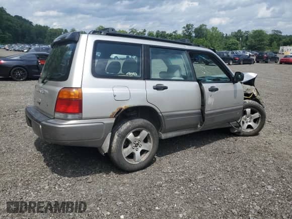 1999 Subaru Forester S with VIN JF1SF6557XH730701, listed as a Copart auction lot 65169235 with 142,246 mi miles and Salvage title. Bid and sale history available at DreamBid. Image 3.