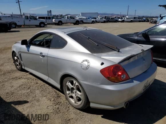 2003 Hyundai Tiburon GT с VIN KMHHN65F83U024950, выставлен на аукционе Copart как лот 70780994 с пробегом 178 681 миль миль и Списание • Salvage title. История ставок и продаж доступна на DreamBid. Изображение 2.