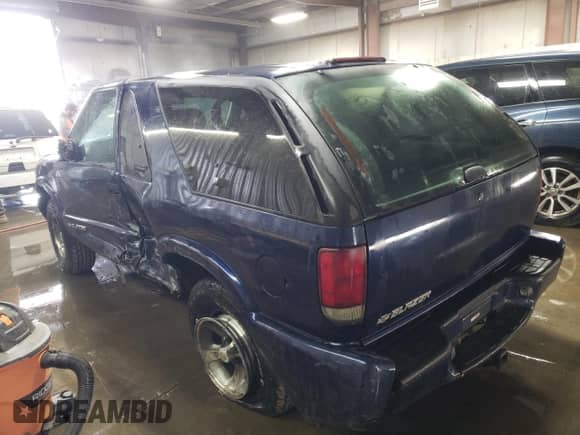 2005 Chevrolet Blazer z VIN 1GNCS18X65K101710, wystawiony jako Copart lot #76982844 z przebiegiem 129 988 mil mil oraz Szkoda całkowita • Salvage title. Historia ofert i sprzedaży dostępna na DreamBid. Obrazek 2.