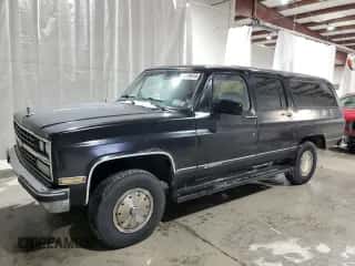 1990 Chevrolet Suburban с VIN 1GNGV26K0LF136318, выставлен на аукционе Copart как лот 87379974 с пробегом 99 730 миль миль и Чистый • Clean title. История ставок и продаж доступна на DreamBid. Изображение 1.