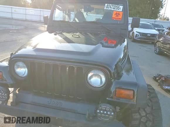 1997 Jeep Wrangler Sahara with VIN 1J4FY49SXVP486730, listed as a Copart auction lot 82473255 with 143,015 mi miles and Salvage title. Bid and sale history available at DreamBid. Image 14.