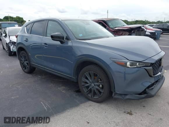 2023 Mazda CX-5 S Carbon Edition z VIN JM3KFBCM1P0132803, wystawiony jako IAAI lot #43128566 z przebiegiem 37 967 mil mil oraz . Historia ofert i sprzedaży dostępna na DreamBid. Obrazek 1.