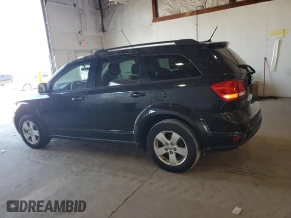 2012 Dodge Journey SXT with VIN 3C4PDCBG0CT144203, listed as a Copart auction lot 70664645 with 135,455 mi miles and Salvage title. Bid and sale history available at DreamBid. Image 2.