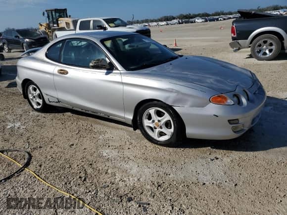 2001 Hyundai Tiburon с VIN KMHJG35F81U246024, выставлен на аукционе Copart как лот 77709294 с пробегом 127 057 миль миль и На запчасти • Non repairable. История ставок и продаж доступна на DreamBid. Изображение 4.