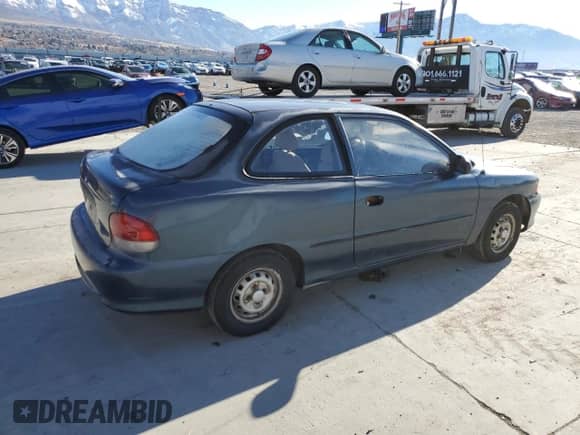 1999 Hyundai Accent L z VIN KMHVD14N3XU456921, wystawiony jako Copart lot #44805175 z przebiegiem 112 134 mil mil oraz Czysty tytuł • Clean title. Historia ofert i sprzedaży dostępna na DreamBid. Obrazek 3.