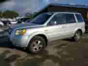 2006 Honda Pilot EX-L z VIN 5FNYF28736B051064, wystawiony jako Copart lot #87474404 z przebiegiem 198 262 mil mil oraz Szkoda całkowita • Salvage title. Historia ofert i sprzedaży dostępna na DreamBid. Obrazek 1.