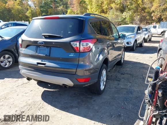 2018 Ford Escape SE z VIN 1FMCU9GD2JUA11554, wystawiony jako IAAI lot #43472518 z przebiegiem 126 525 mil mil oraz . Historia ofert i sprzedaży dostępna na DreamBid. Obrazek 4.