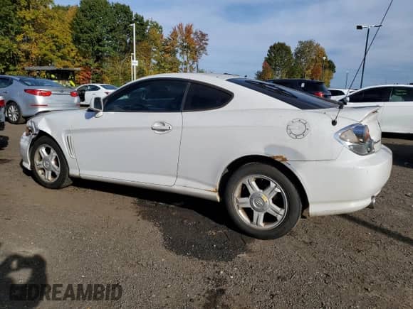 2003 Hyundai Tiburon GT с VIN KMHHN65FX3U096958, выставлен на аукционе Copart как лот 75451144 с пробегом 200 579 миль миль и Списание • Salvage title. История ставок и продаж доступна на DreamBid. Изображение 2.