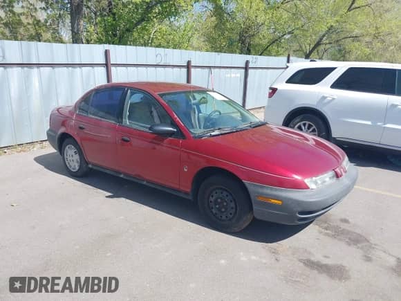 1996 Saturn SL z VIN 1G8ZG5289TZ214790, wystawiony jako IAAI lot #42090262 z przebiegiem 197 485 mil mil oraz . Historia ofert i sprzedaży dostępna na DreamBid. Obrazek 1.