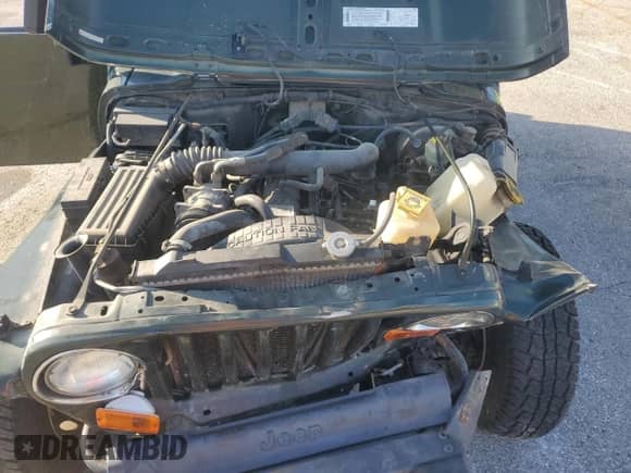 1998 Jeep Wrangler Sport z VIN 1J4FY19S5WP755118, wystawiony jako Copart lot #66572805 z przebiegiem 279 594 mil mil oraz Szkoda całkowita • Salvage title. Historia ofert i sprzedaży dostępna na DreamBid. Obrazek 11.