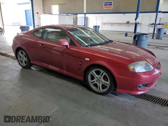 2006 Hyundai Tiburon GT with VIN KMHHN65F06U212592, listed as a Copart auction lot 71478344 with 121,574 mi miles and Salvage title. Bid and sale history available at DreamBid. Image 4.