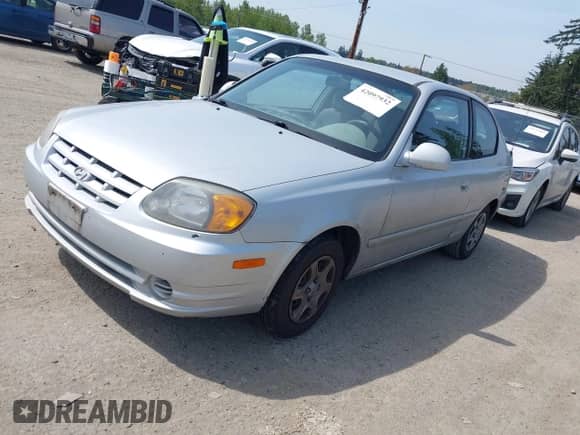 2005 Hyundai Accent GLS z VIN KMHCG35C65U332999, wystawiony jako IAAI lot #42097932 z przebiegiem 225 593 mil mil oraz . Historia ofert i sprzedaży dostępna na DreamBid. Obrazek 2.