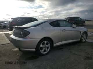 2006 Hyundai Tiburon GS z VIN KMHHM65D06U205823, wystawiony jako Copart lot #87125445 z przebiegiem 158 410 mil mil oraz Czysty tytuł • Clean title. Historia ofert i sprzedaży dostępna na DreamBid. Obrazek 3.