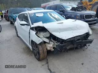 2014 Hyundai Veloster Turbo z VIN KMHTC6AE8EU195925, wystawiony jako IAAI lot #43149493 z przebiegiem 156 100 mil mil oraz . Historia ofert i sprzedaży dostępna na DreamBid. Obrazek 1.