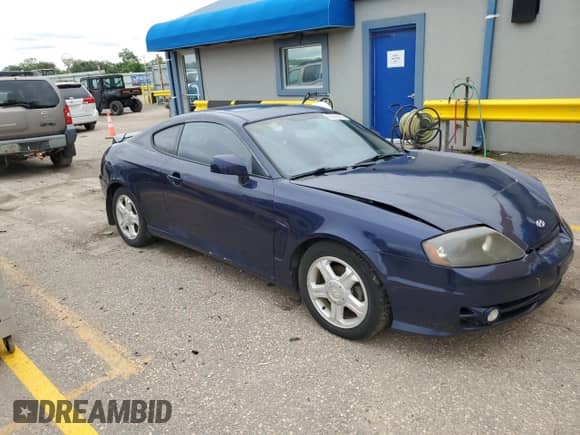 2003 Hyundai Tiburon GT with VIN KMHHN65F73U018847, listed as a Copart auction lot 58242385 with 164,976 mi miles and Salvage title. Bid and sale history available at DreamBid. Image 4.