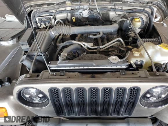 2004 Jeep Wrangler Sport z VIN 1J4FA49S14P768676, wystawiony jako Copart lot #69976745 z przebiegiem 165 894 mil mil oraz Szkoda całkowita • Salvage title. Historia ofert i sprzedaży dostępna na DreamBid. Obrazek 12.