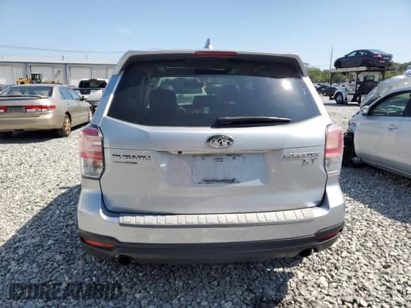 2018 Subaru Forester Premium with VIN JF2SJGECXJH411587, listed as a Copart auction lot 68100385 with 99,274 mi miles and Salvage title. Bid and sale history available at DreamBid. Image 6.