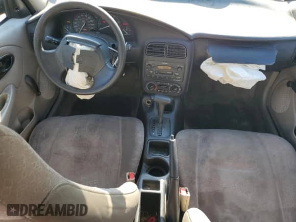 2001 Saturn SL with VIN 1G8ZH54841Z290618, listed as a Copart auction lot 77850194 with 128,083 mi miles and Salvage title. Bid and sale history available at DreamBid. Image 8.