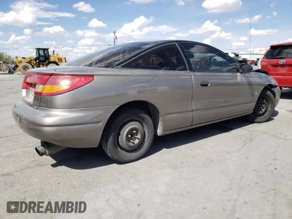 1999 Saturn SC with VIN 1G8ZN1288XZ310351, listed as a Copart auction lot 76677414 with Not provided miles and Salvage title. Bid and sale history available at DreamBid. Image 3.