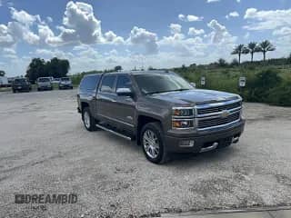 2015 Chevrolet Silverado 1500 High Country with VIN 3GCUKTEC9FG511775, listed as a Copart auction lot 85567475 with 134,304 mi miles and Salvage title. Bid and sale history available at DreamBid. Image 1.