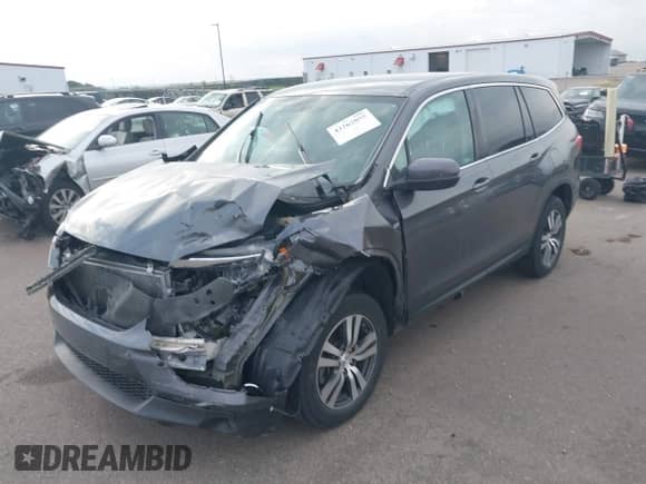 2018 Honda Pilot EX with VIN 5FNYF6H33JB044757, listed as a IAAI auction lot 43262855 with 106,702 mi miles and . Bid and sale history available at DreamBid. Image 2.