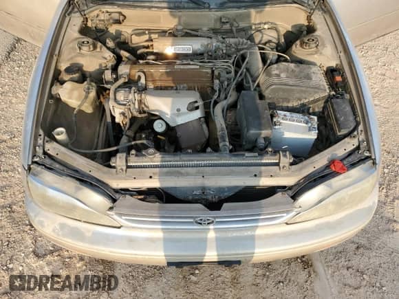 1995 Toyota Camry LE z VIN 4T1SK12C7SU548827, wystawiony jako Copart lot #64502944 z przebiegiem 215 266 mil mil oraz Szkoda całkowita • Salvage title. Historia ofert i sprzedaży dostępna na DreamBid. Obrazek 12.