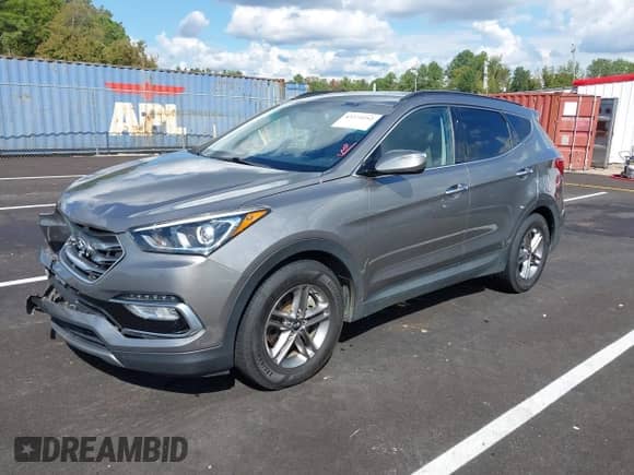 2018 Hyundai Santa Fe 2.4L z VIN 5NMZU3LBXJH098272, wystawiony jako IAAI lot #43375252 z przebiegiem 96 576 mil mil oraz . Historia ofert i sprzedaży dostępna na DreamBid. Obrazek 2.