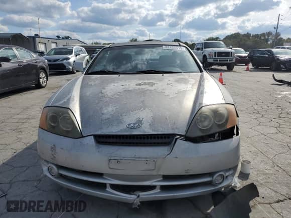 2003 Hyundai Tiburon GT z VIN KMHHN65F03U055237, wystawiony jako Copart lot #82400615 z przebiegiem 244 468 mil mil oraz Szkoda całkowita • Salvage title. Historia ofert i sprzedaży dostępna na DreamBid. Obrazek 5.