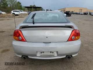 2003 Hyundai Tiburon GT с VIN KMHHN65F13U013420, выставлен на аукционе Copart как лот 51234495 с пробегом 230 612 миль миль и Списание • Salvage title. История ставок и продаж доступна на DreamBid. Изображение 6.