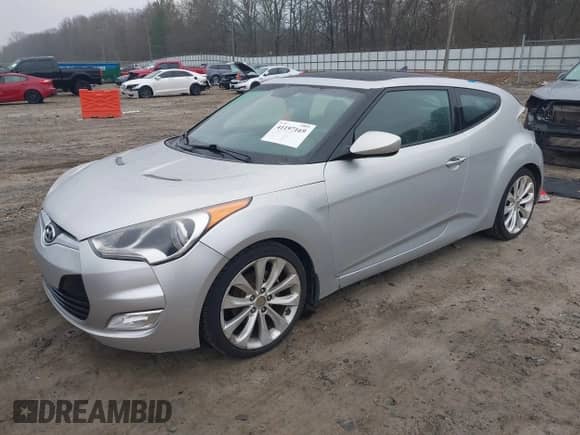 2012 Hyundai Veloster w/Gray Int z VIN KMHTC6AD1CU072228, wystawiony jako IAAI lot #41197169 z przebiegiem 214 994 mil mil oraz . Historia ofert i sprzedaży dostępna na DreamBid. Obrazek 2.