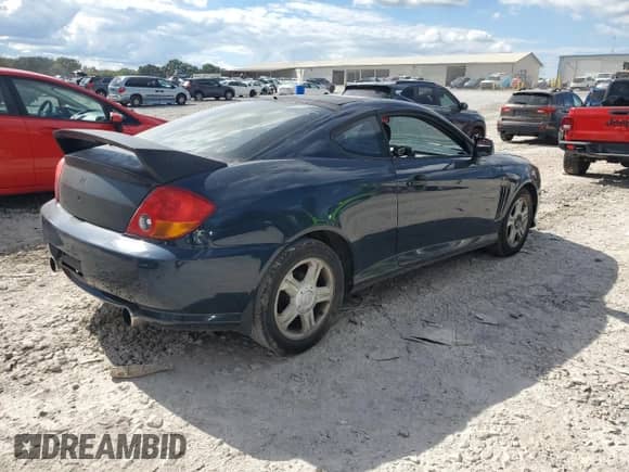 2003 Hyundai Tiburon GT с VIN KMHHN65F03U066786, выставлен на аукционе Copart как лот 84249025 с пробегом 178 084 миль миль и Чистый • Clean title. История ставок и продаж доступна на DreamBid. Изображение 3.