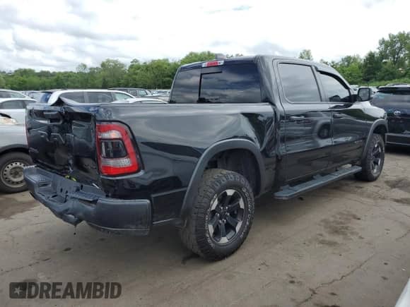 2023 Ram 1500 Rebel with VIN 1C6SRFLT9PN590999, listed as a Copart auction lot 63325355 with 82,896 mi miles and Salvage title. Bid and sale history available at DreamBid. Image 3.