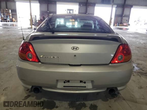 2004 Hyundai Tiburon GS z VIN KMHHM65D74U144595, wystawiony jako Copart lot #84241315 z przebiegiem 184 108 mil mil oraz Szkoda całkowita • Salvage title. Historia ofert i sprzedaży dostępna na DreamBid. Obrazek 6.