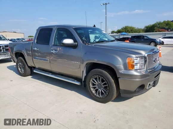 2012 GMC Sierra 1500 Denali with VIN 3GTP2XE26CG209304, listed as a Copart auction lot 71415545 with 130,199 mi miles and Salvage title. Bid and sale history available at DreamBid. Image 4.
